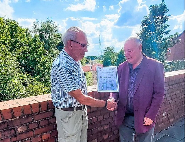 SENRUG Chair Dennis Fancett collects the Railfuture awards, at Seaton Delaval station site